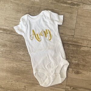 Avery White Onesie with Gold Script